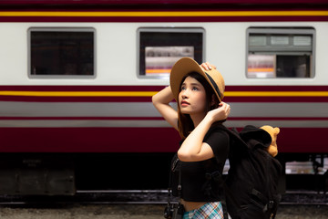 Portrait charming beautiful woman. Attractive beautiful tourist women is looking nice view at tourist attraction or retro train station in the early morning. Pretty girl is going to some destination