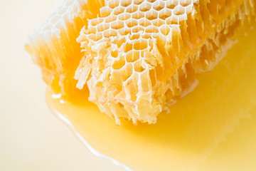 Piece of honeycomb with honey in closeup, healthy products by organic ingredients