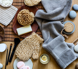 natural sponge, loofah, towel, soap and makeup brushes, top view