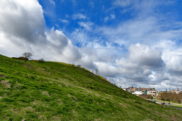 Fototapeta premium A hillwalking route through grassy slopes up to Arthur’s Seat, the highest point in Edinburgh located at Holyrood Park, Scotland, UK