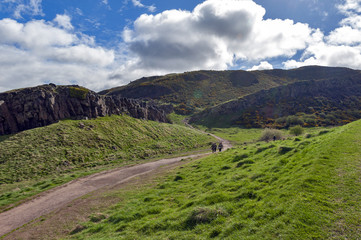 Fototapeta na wymiar A hillwalking route through grassy slopes up to Arthur’s Seat, the highest point in Edinburgh located at Holyrood Park, Scotland, UK