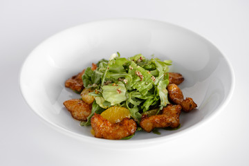 Juicy salad with chicken steak, salad mix, orange, cheese. Under the olive oil.