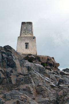 The stone landmark monument at the summit of Arthur’s Seat, the highest point in Edinburgh located at Holyrood Park in Edinburgh, Scotland, UK