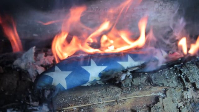 American flag being retired in a fire. 