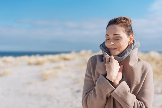 Attractive woman on a beach in cold weather