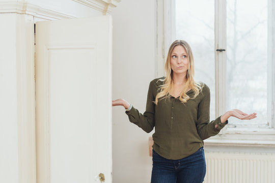 Young Woman Shrugging Her Shoulders In Confusion