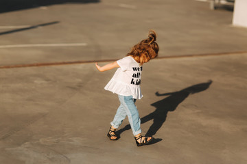 beautiful little girl having fun in the city. we are all kids