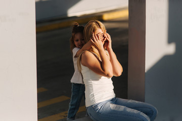 Mom plays with her daughter on a summer sunny day