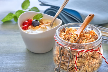 Jar of muesli with yogurt, honey and berries, healthy dessert