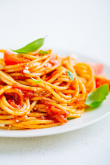 Pasta dish with tomato sauce on white plate