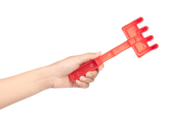 hand holding toy of shovel isolated on a white background.