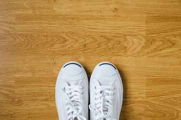 White sneakers on wood background, concept Copy space