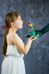 The girl with snowflakes on her face is smelling of dry roses.The Snow White Fairytale.A little...