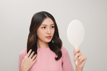 health, beauty and spa - smiling woman looking at mirror