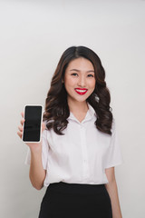 happy smiling woman showing mobile phone isolated in white background