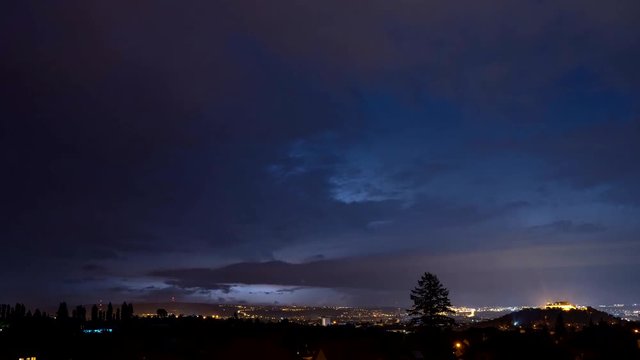 Time-lapse footage of stormy night over city Brno, Czech Republic. Thunderstorm lighting all over night sky.