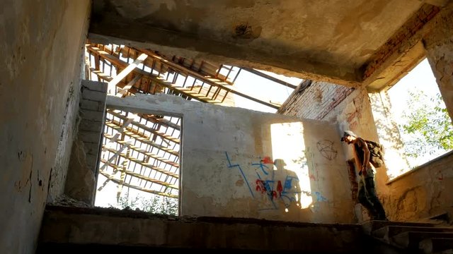 Traveler explores big ruins of a building with hard sunlight