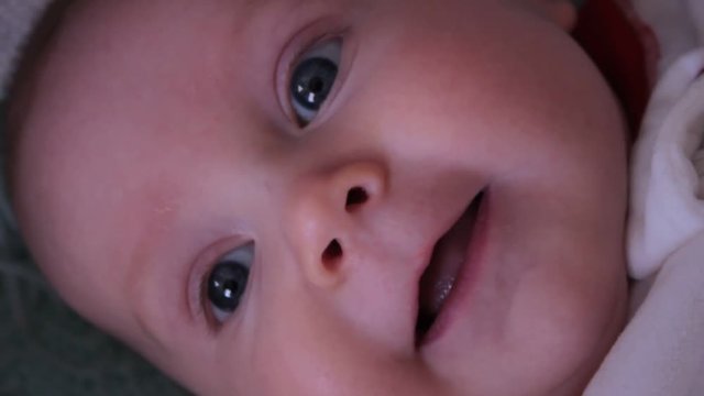 Close up of happy 2 month old baby boy talking, making noises and smiling.
[link]https://www.pond5.com/stock-footage/20476130 Want this clip, but so close? click here.[/link]