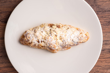 Almond croissant  filled with almond cream and topped with sliced almonds