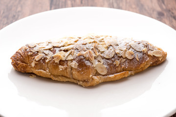 Almond croissant  filled with almond cream and topped with sliced almonds