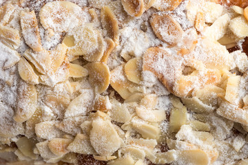 Fototapeta na wymiar Almond croissant filled with almond cream and topped with sliced almonds