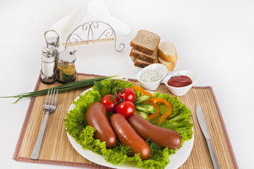 Boiled sausages with tomatoes, cucumbers and greens. Served with black or white bread.