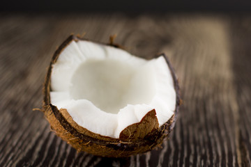 Broken coconut on a wooden background.Selective focus.