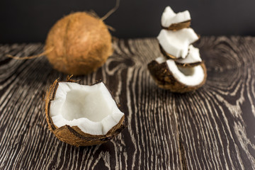 Broken coconut on a wooden background.Selective focus.