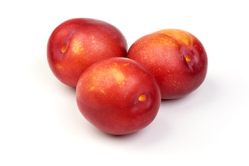 Fototapeta na wymiar Ripe sweet red plums, isolated on white background. Close-up.