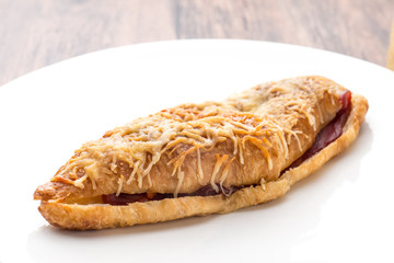 croissant ham cheese on white plate