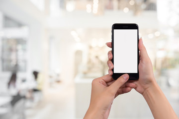 Young woman holding smart phone with blurred background. For Graphic display