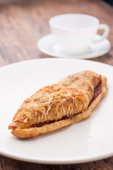 croissant ham cheese on white plate