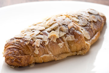 Almond croissant  filled with almond cream and topped with sliced almonds