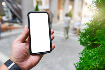 Man holding smart phone with blurred background
