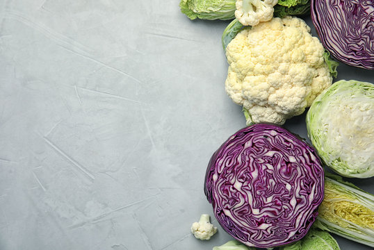 Flat lay composition with different cabbages on grey background