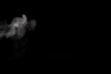 Fototapeta premium White smoke isolated on black background.