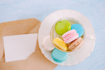 Colorful pastel cake macaron or macaroon on plate.