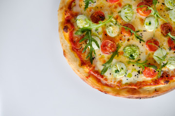Pizza with tomatoes and arugula and mozzarella