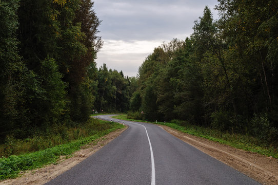 Fototapeta Asphalt road through the forest