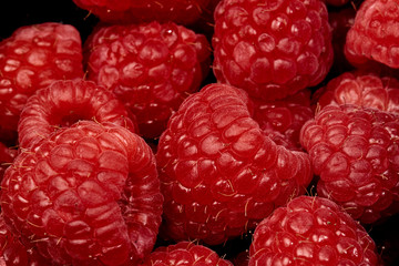 Fresh, beautiful, large raspberries blueberries, strawberries, blackberries photographed in macro close-up Packed in a container in high quality.