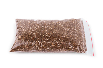 Chia seeds in polyethylene bag on white background
