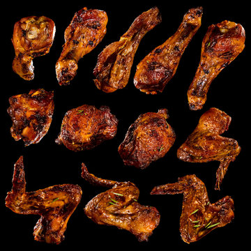 Chicken legs and wings isolated on black background.