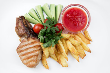 Grilled steak with potatoes and vegetables on white plate.