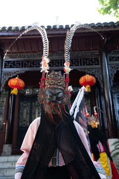 Fototapeta Miao person wearing traditional mask