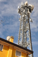 Telecommunication tower with antennas over the top of a building