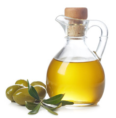Bottle of olive oil and green olives with leaves