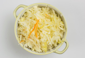 Sauerkraut in a bowl on a light background.