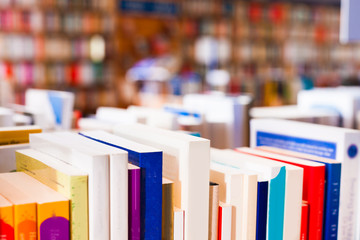 stack of books lying on table in bookstore