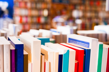 different books lying on table in library