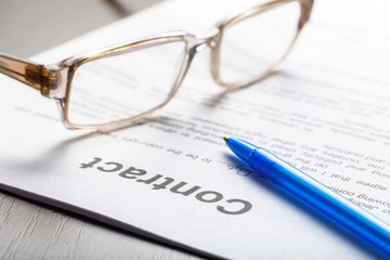 Close up shot of Eyeglasses  on contract document papers business concept